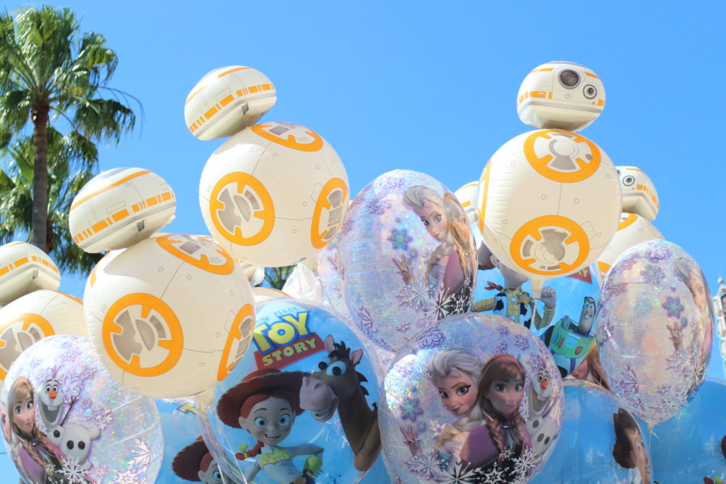 Disney BB8 shaped, Toy Story and Frozen Balloons in front of a blue sky