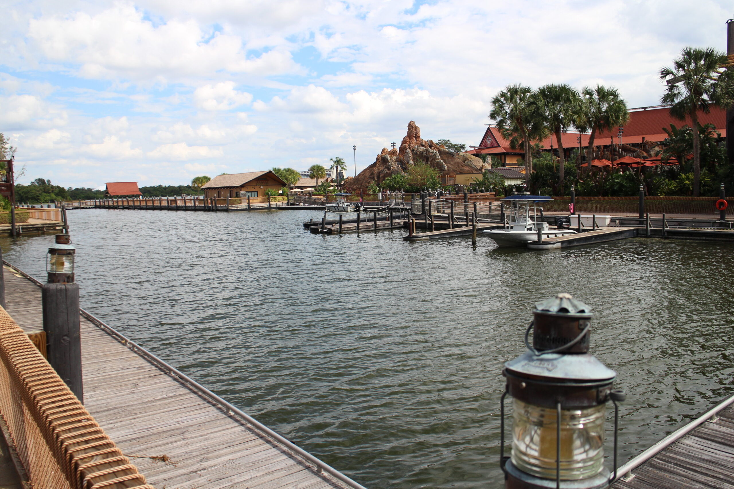 A view of the marina water with surrounding docks and Polynesian themed buildings in the distance