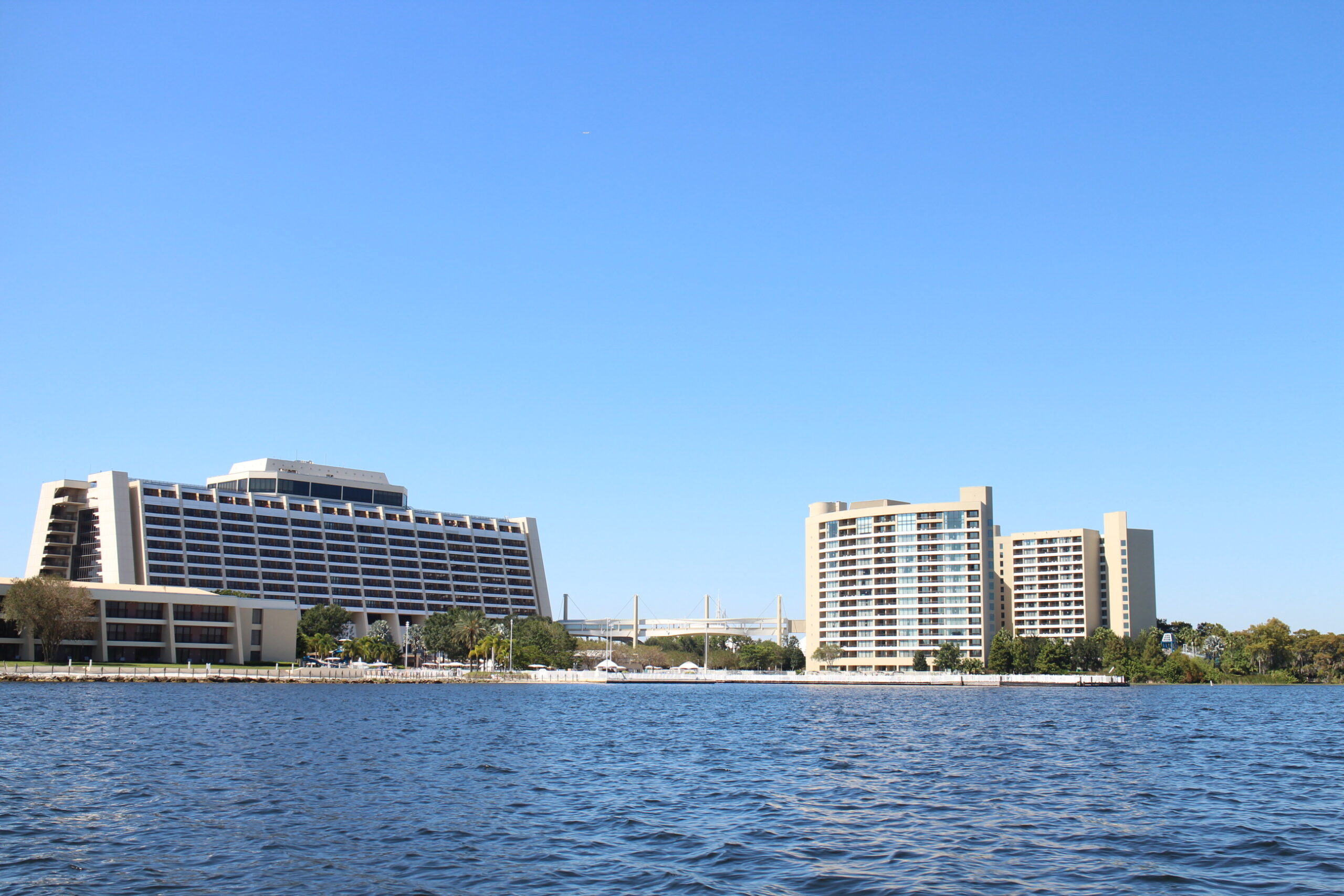 Bay Lake's blue waters with the Contemporary resort on the left and Bay Lake Tower on the right under a blue, cloudless sky How do I sell DVC points?