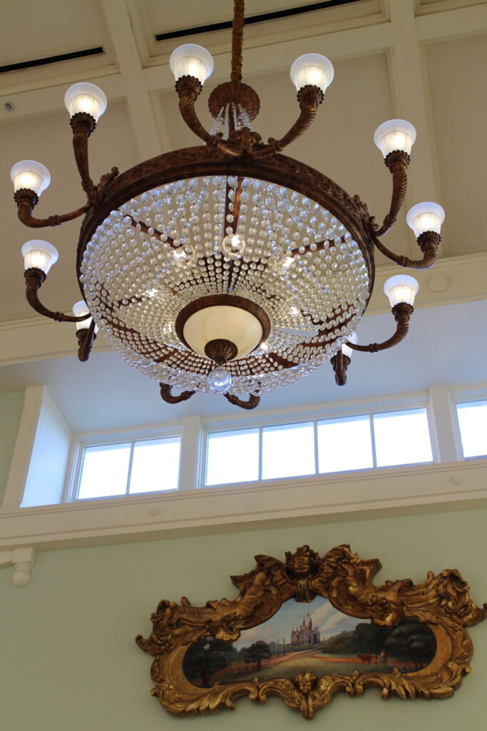 BoardWalk lobby chandelier and ornate art in gold frame