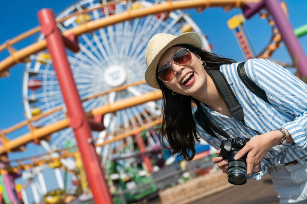 lady with camera on vacation at amusement park