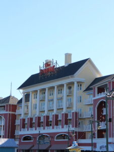 The BoardWalk sign in red lettering on top of a muted yellow and muted red building at the Disney's Vacation Club resort of the same name