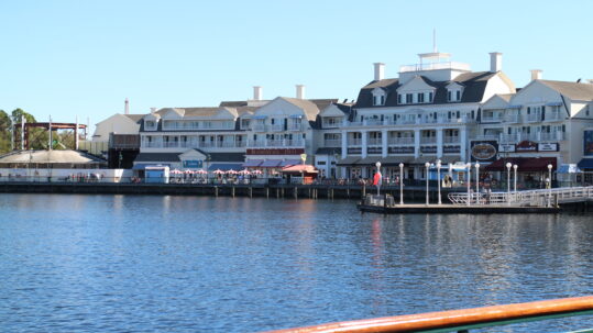 Disney's BoardWalk Resort sits over a day time lake view