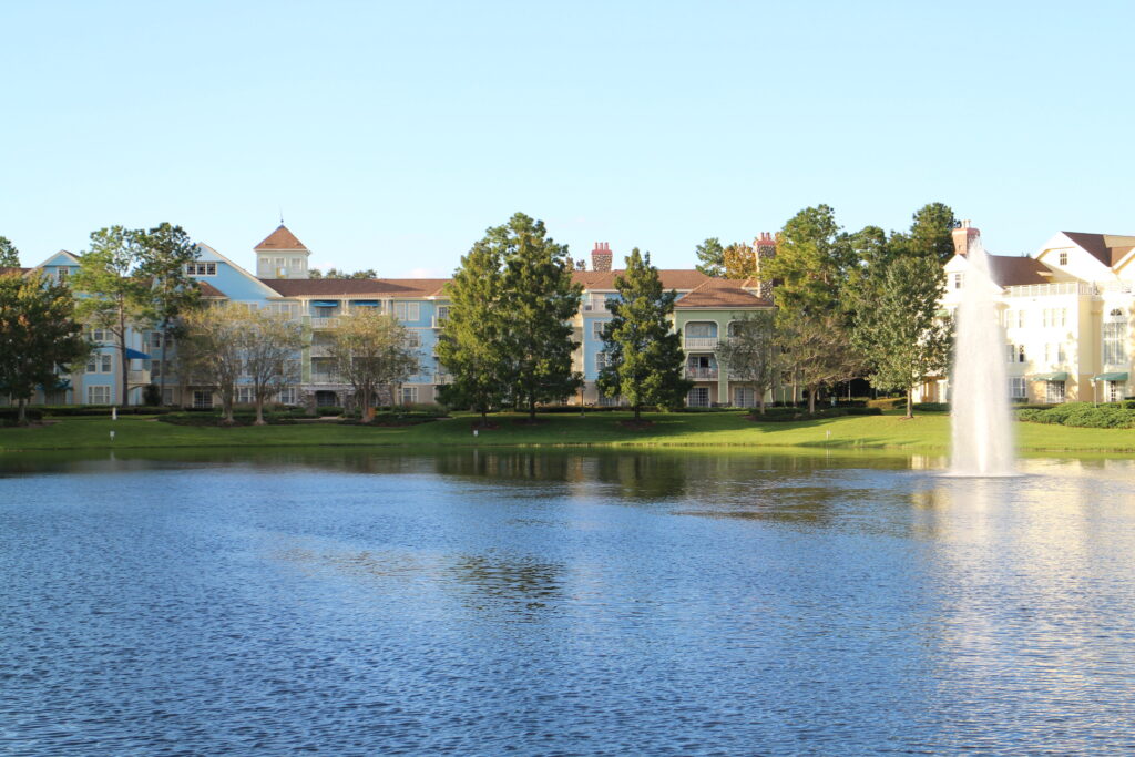 A calm pond with Saratoga Springs resort building in the background