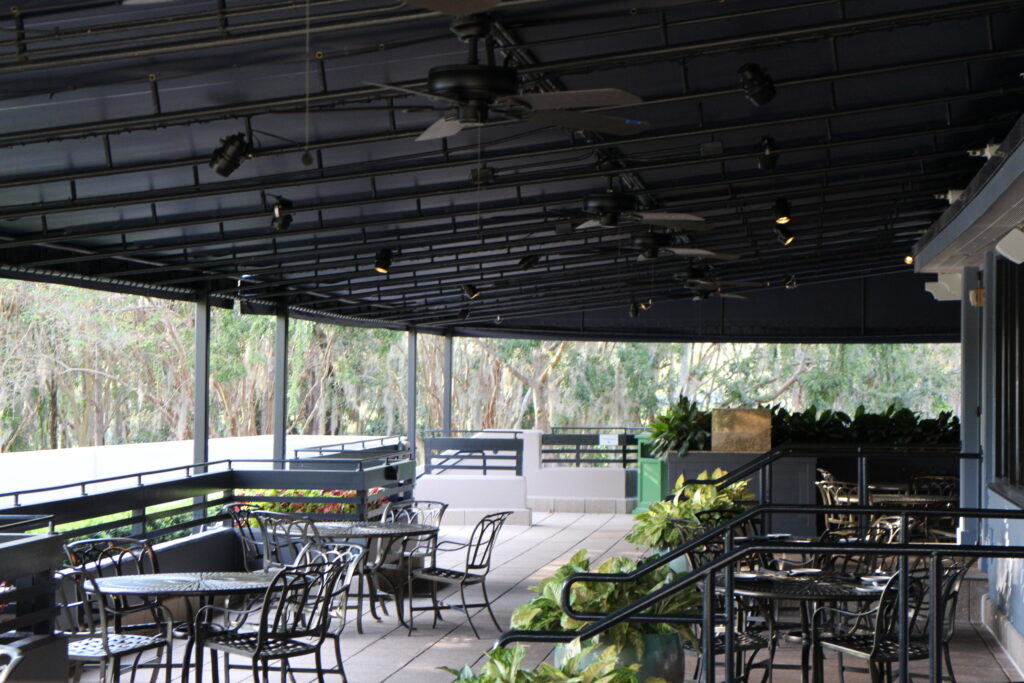The Turf Club Bar and Grill is one of the Saratoga Springs restaurants with outdoor seating that's covered and has fans.