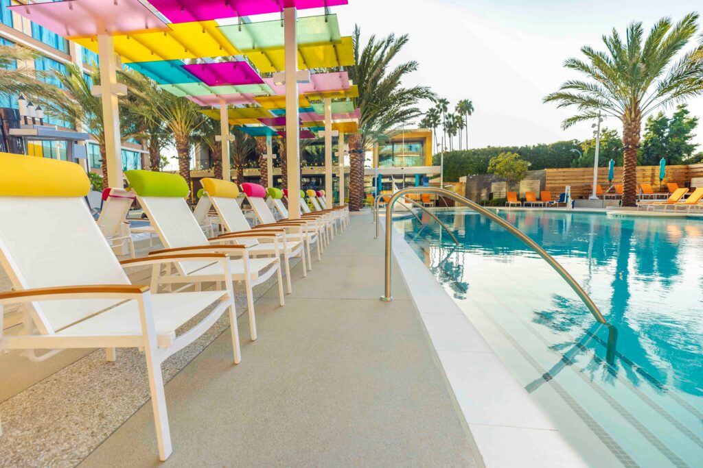 White chairs with colorful headrests at the Palette Pool at Disneyland Hotel DVC tower