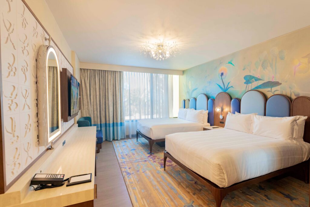 Bright bedroom with fantasia characters and two beds in Disneyland Hotel DVC tower