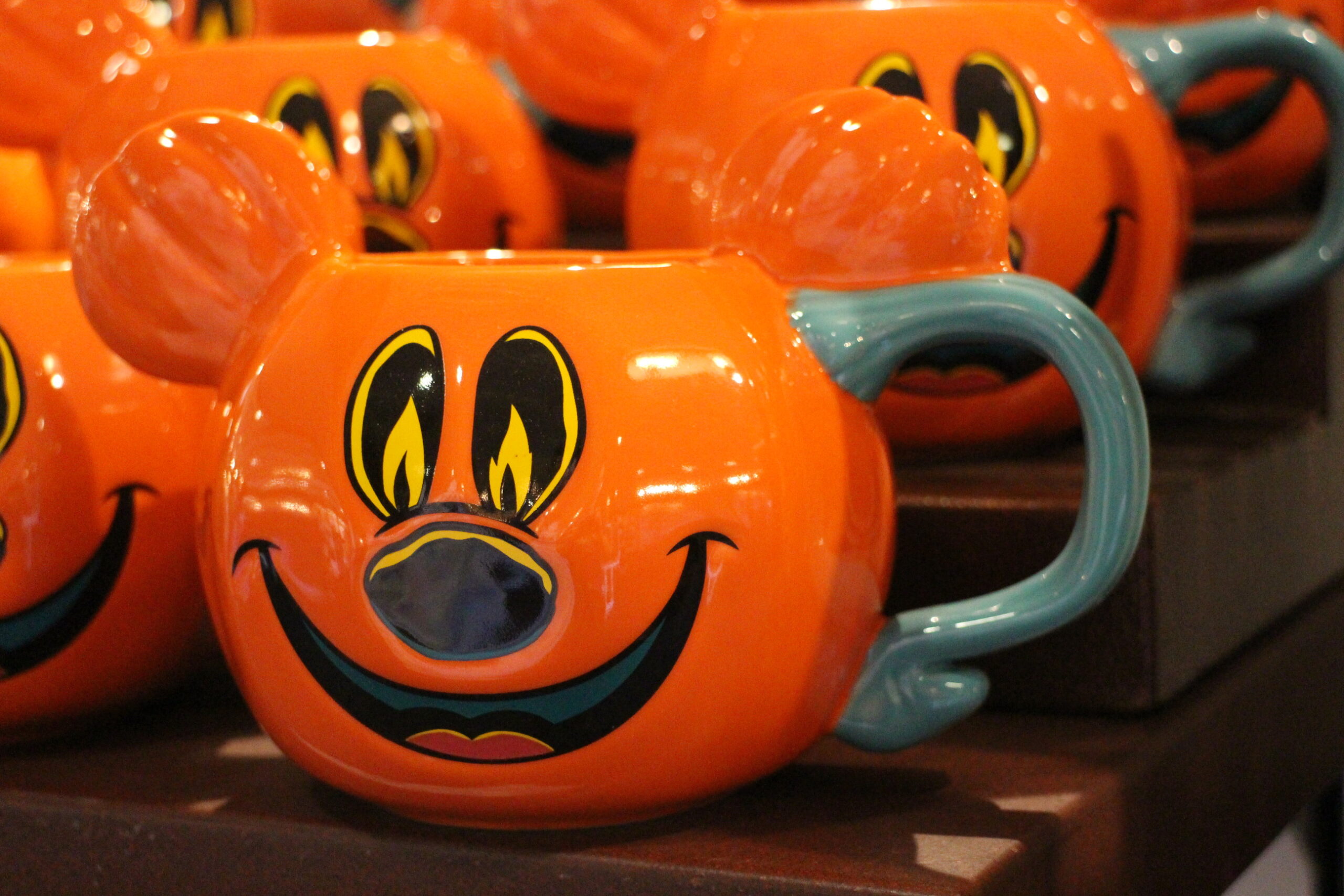 Orange pumpkin mug with Mickey's face on it