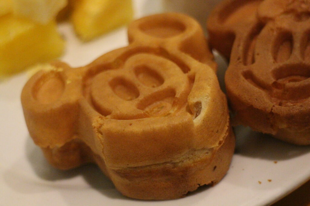 a crispy Mickey shaped waffle on a white plate