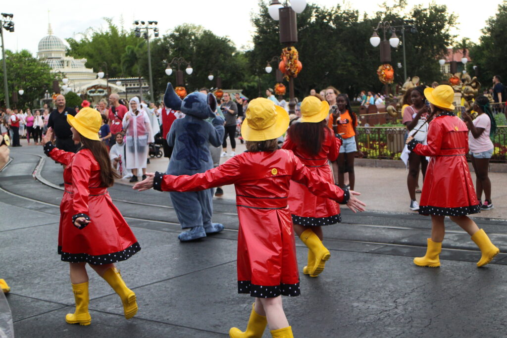 Magic Kingdom Rainy Day Cavalcade performers in rain jackets and rain boots