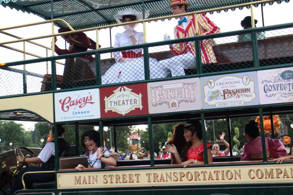 Rainy Day Cavalcade Main Street Ride Vehicle carrying characters like Mary Poppins and Mirabel from Encanto at Disney World