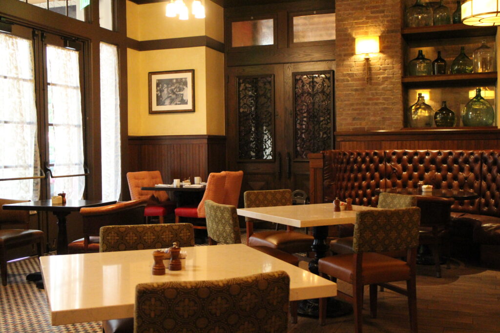 dark interiors with bright tables inside Trattorial al Forno Disney BoardWalk Restaurant