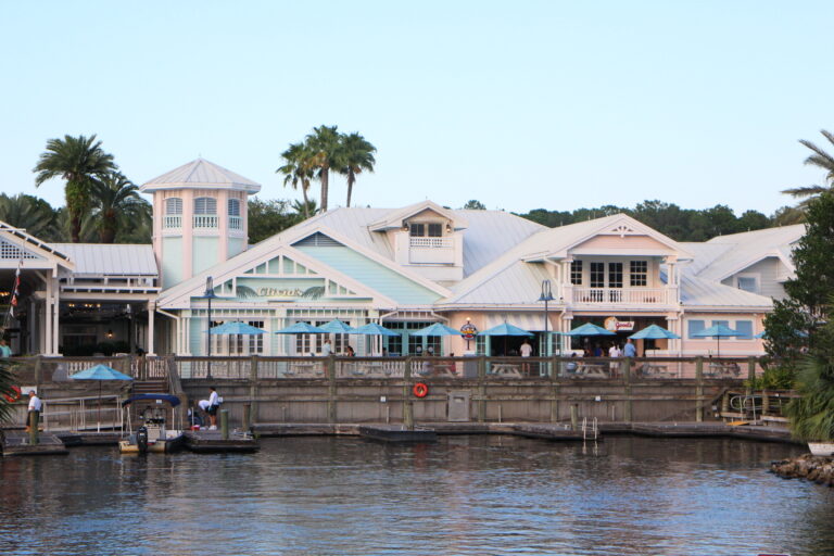 a set of pastel buildings on a body of water