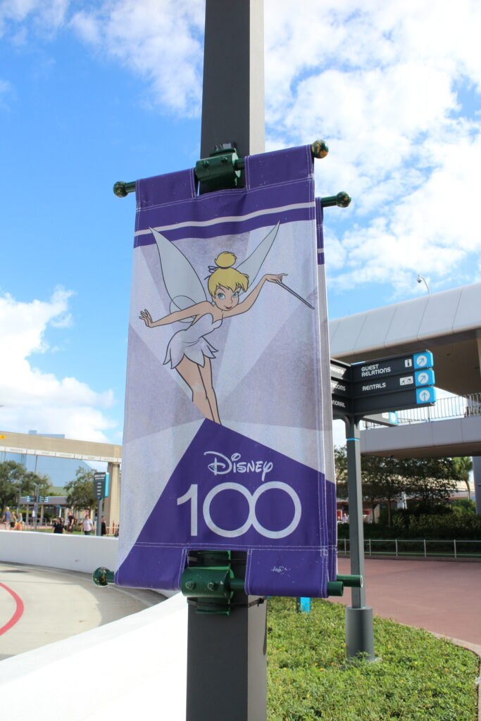 a Disney 100 Tinker Bell sign at Epcot