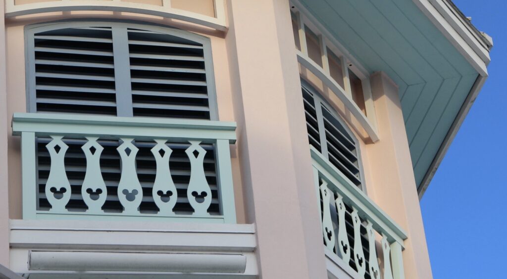 a close up of a tall building at Disney's Old Key West Resort with Mickey cutouts in the railing