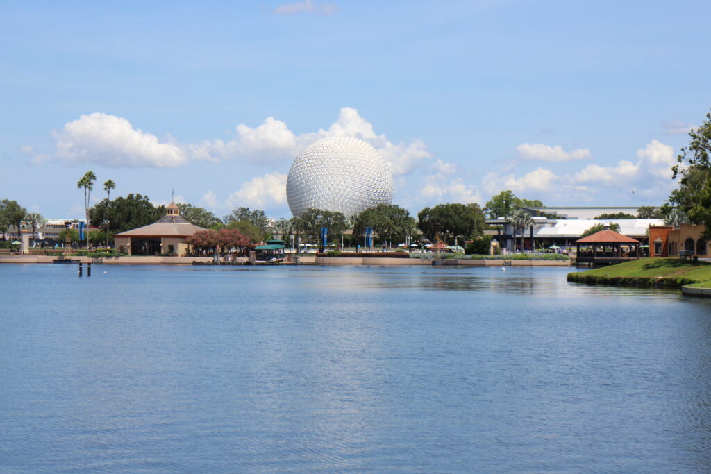 World Showcase Lagoon and Spaceship Earth in front of a very blue Florida sky with clouds