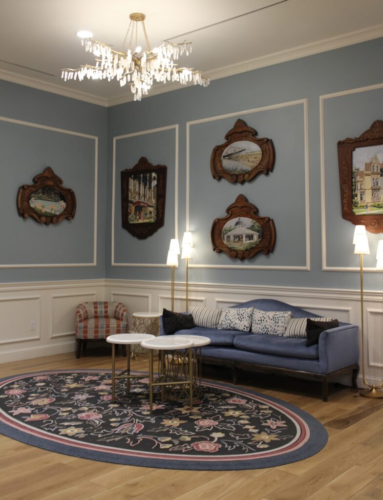 Saratoga Springs lobby seating area with blue furnishings and antique style art