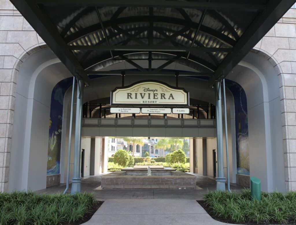 Outdoor hall to enter Disney's Riviera Resort with a sign that says the resort name