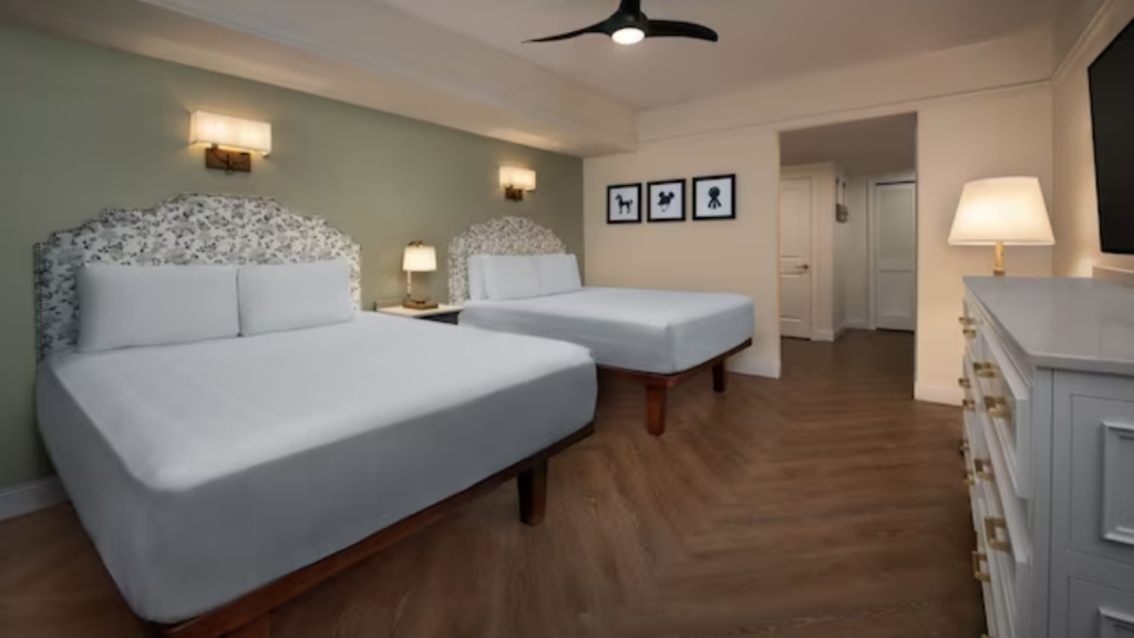 Two queen size beds with white sheets in a Saratoga Springs Two Bedroom Villas bedroom
