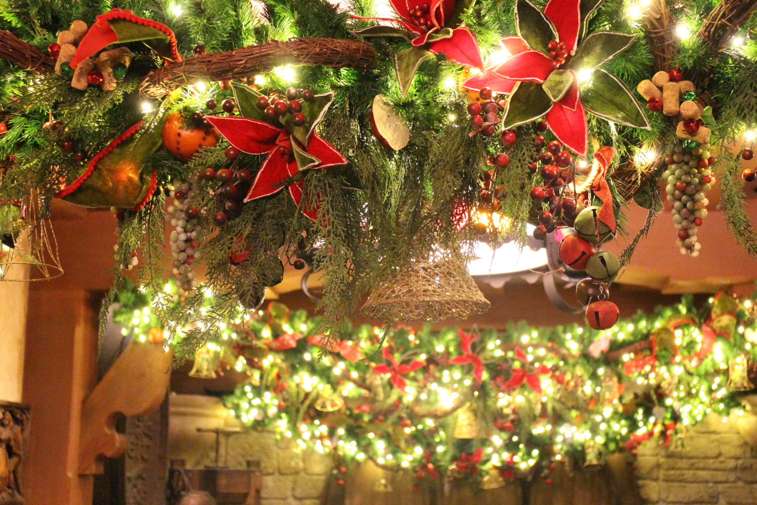 hanging green garlands with red bows and berries