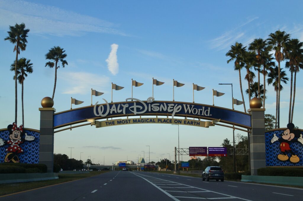 Disney World tips for first timers blue, gold and gray entrance gate with Mickey and Minnie mouse on each side