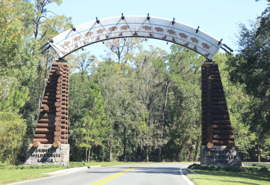 a rustic gate in front of the Wilderness Lodge wooded property