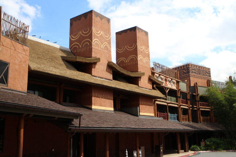 The entrance of Animal Kingdom Lodge with ornate, African inspired, earth tone architecture.