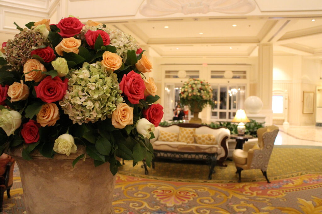 A floral arrangement featuring pink and white roses and green and white hydrangeas in the chic Grand Floridian resort lobby.