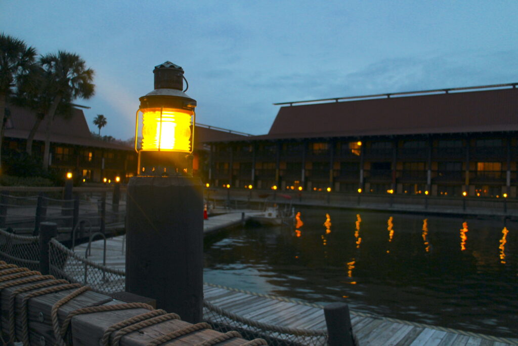 A light shines bright in the otherwise near dark Polynesian resort marina.
