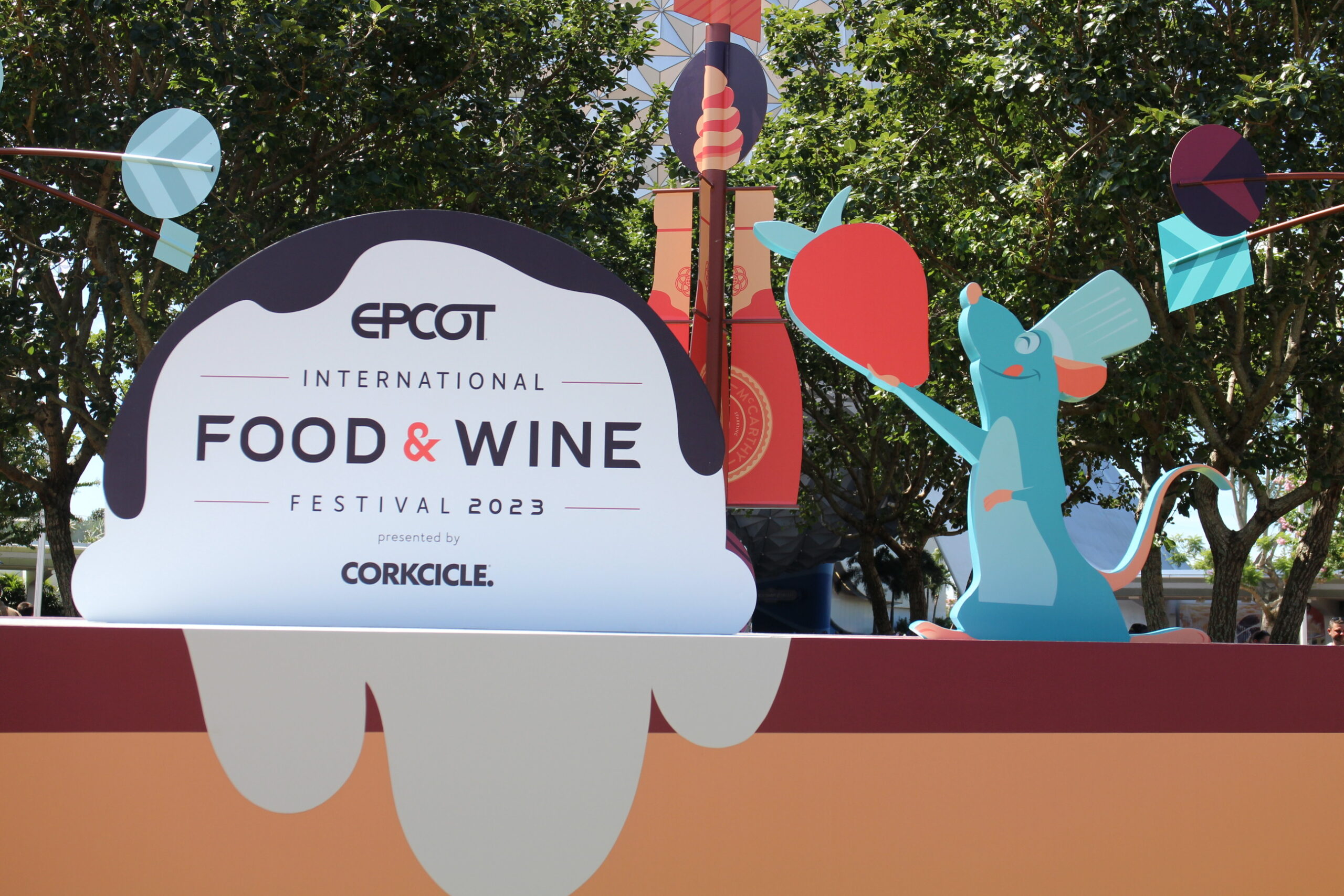 Epcot Food and Wine 2023 Entrance Sign featuring Remy the rat holding a strawberry