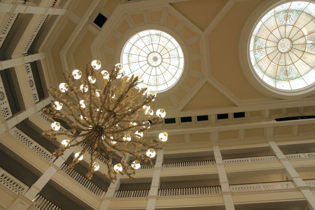 A look at the Grand Floridian resort chandelier and ceiling which was painted cream in 2024.
